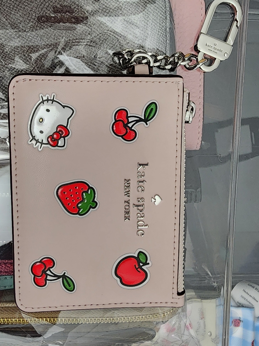 kate spade pale pink leather zip card case with fruit and Hello Kitty charms
